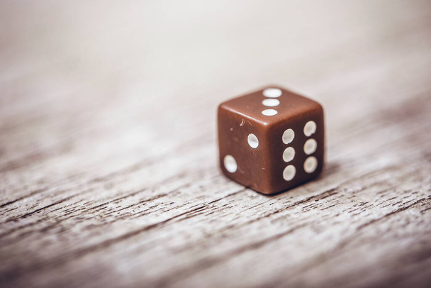 Dice on table, vintage effect. Background for casino games, gambling, luck or randomness. Rolling the dice concept for business risk, chance, good luck or gambling. - Photo, Image