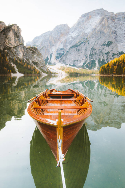 Beautiful view of traditional wooden rowing boat on scenic Lago di Braies in the Dolomites in scenic morning light at sunrise, South Tyrol, Italy - Fotografie, Obrázek