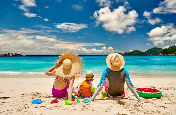 Family on beach, young couple with three year old boy. Summer vacation at Seychelles. - Photo, Image