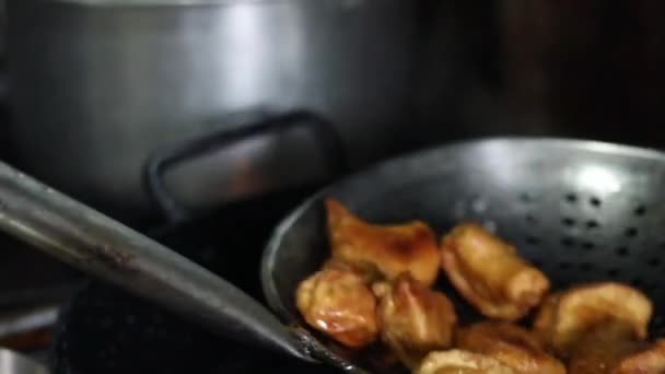 Frying chicken momos or dumplings in an India pan or kadhai with oil. - Πλάνα, βίντεο
