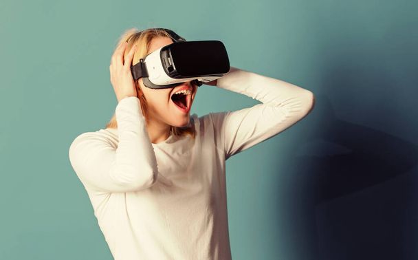 Funny woman experiencing 3D gadget technology - close up. Woman enjoying cyber fun experience in vr. Woman using VR device. VR concept. - Photo, Image