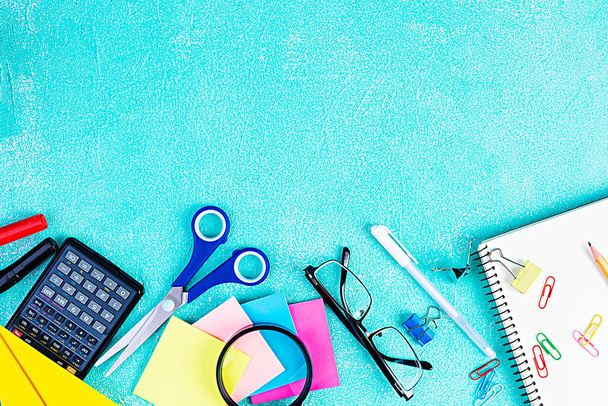 Different school supplies on blue background. Concept Back to school - Photo, Image