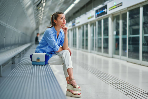 mujer joven con un bolso en la estación de metro
 - Foto, imagen