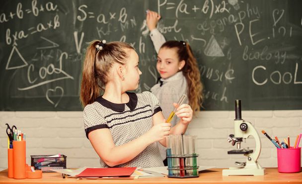 Back to school. School classes. Girls study chemistry in school. Microscope test tubes chemical reactions. Pupils at chalkboard. Fascinating science. Formal education school. Educational experiment - Foto, Bild