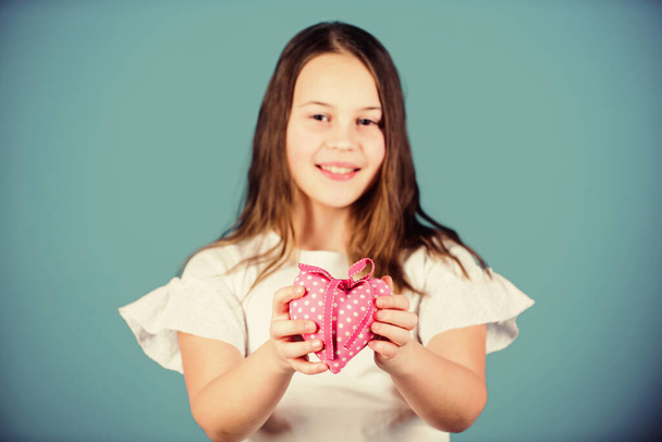 Heart symbol of love. Kid adorable girl happy face show heart blue background. Celebrate valentines day. Love holiday decor. Do not play with my heart. Love concept. Girl cute child show heart toy - Photo, image