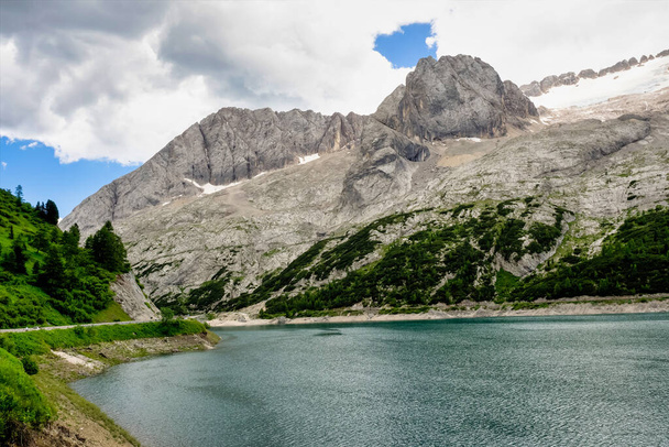 Alpine landscape in the Dolomites, Italy. Glacier Marmolada and Lago di Fedaia. - Photo, Image
