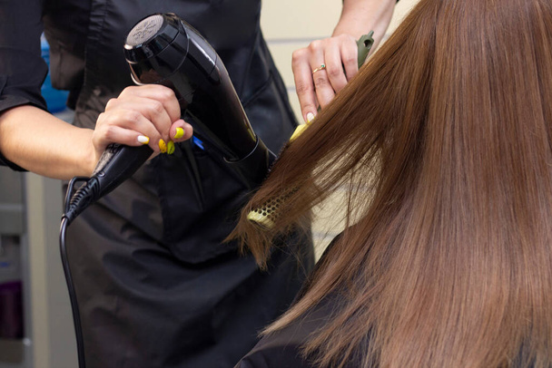 hair dryer drying. hair styling in a beauty salon. hair care. - Фото, зображення