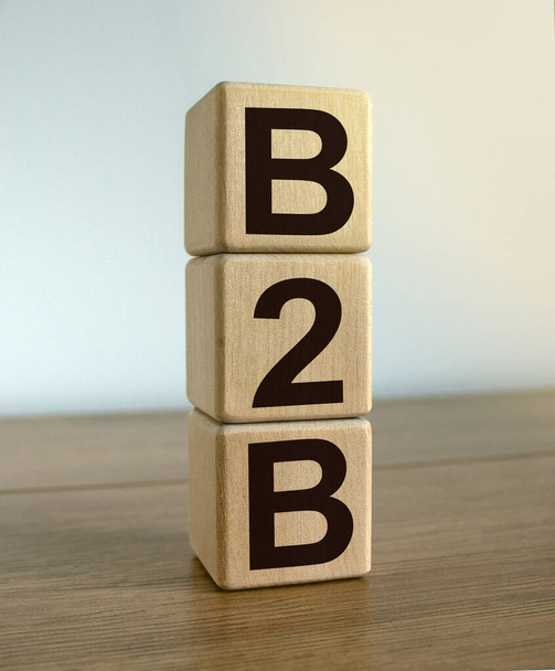 Concept word 'B2B' on cubes on a beautiful white background. Wooden table. Business concept. - Foto, Imagem
