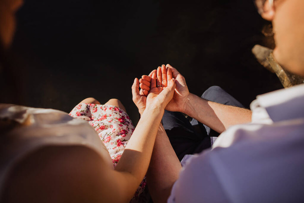 a man and a woman hold each other's hand, wedding ring on the finger, newlyweds together, wedding moment, relationship - Fotografie, Obrázek