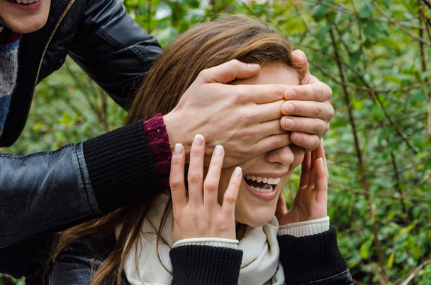 Hands Covering Woman's Eyes In Park - Foto, Imagem