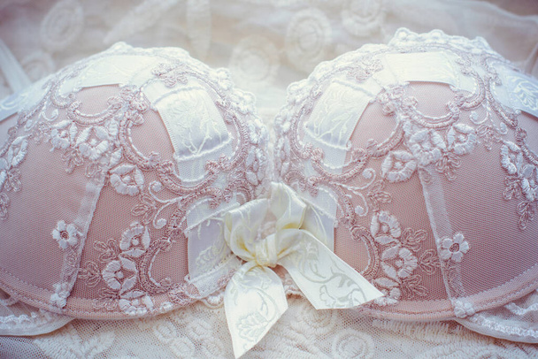 Vintage bra on white oldest lace. Beautiful and tenderness lingerie - Photo, Image