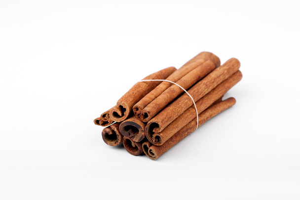 Long cinnamon sticks isolated over white - Fotografie, Obrázek