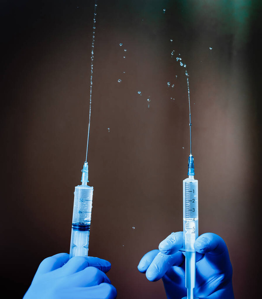 a syringe with a vaccine to work with the covid-19 coronavirus pandemic during the epidemic - Foto, afbeelding