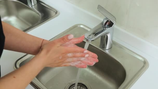 Female hands washes his hands above the washbasin in hospital. Top view - Filmmaterial, Video