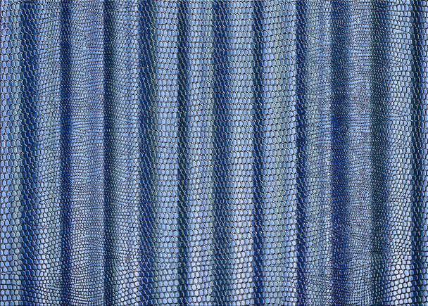 A snakeskin print curtain drape in pale blue for use as a background or texture - Photo, Image