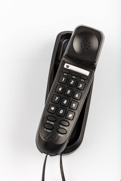 Wall Phone Desk Wandhalterung. Modernes schwarzes Wandtelefon isoliert auf weißem Hintergrund. - Foto, Bild