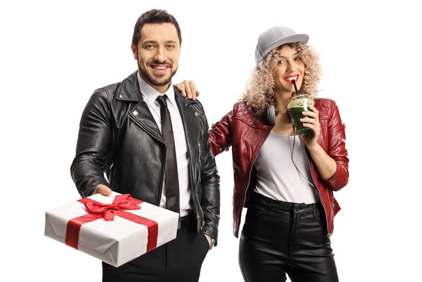 Man holding a present and a young woman holding a green smoothie isolated on white background - Fotoğraf, Görsel