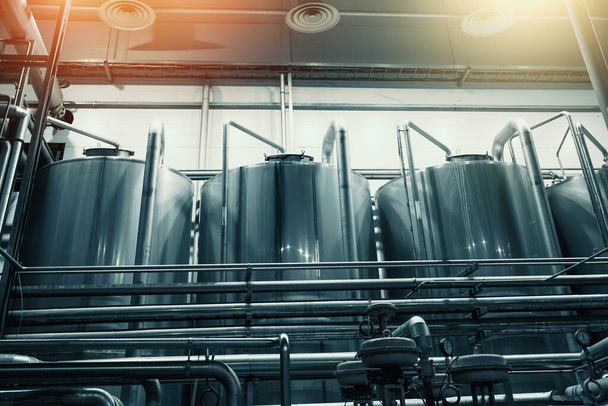Large steel industrial stainless steel vats in modern brewery - Fotó, kép