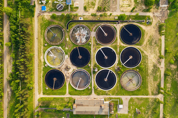 Modern wastewater treatment plant. Water purification tanks, aerial top view - 写真・画像