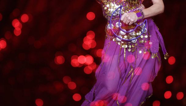 Belly Dancer Close-up with red bokeh - Photo, Image