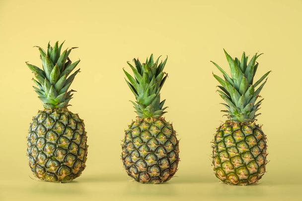Pineapple fruit isolated on yellow background. Healthy lifestyle concept. - Фото, зображення
