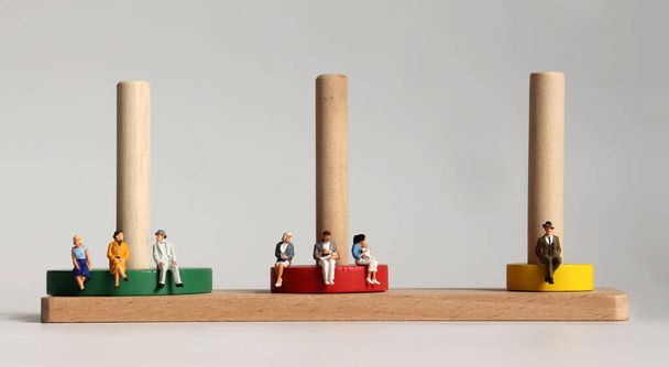Round wooden blocks and miniature people. - Photo, Image