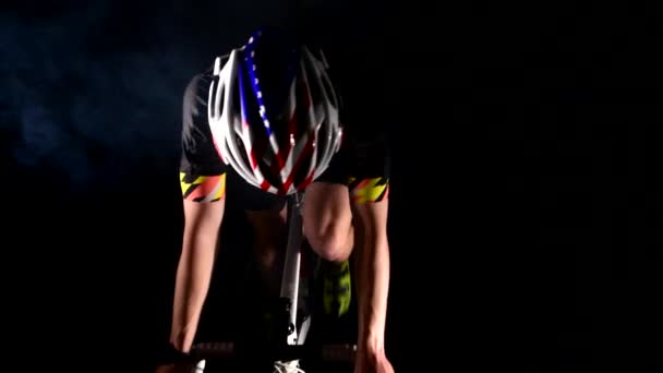 professional triathlete cycling road bike, Pedaling, sport concept, studio black - Footage, Video