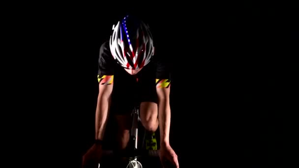 professional triathlete cycling road bike, Pedaling, sport concept, studio black - Footage, Video