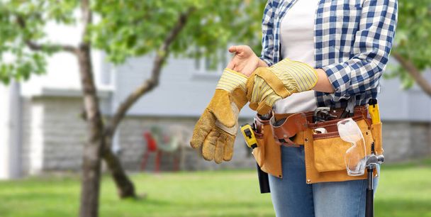 woman or builder with gloves and working tools - Photo, Image