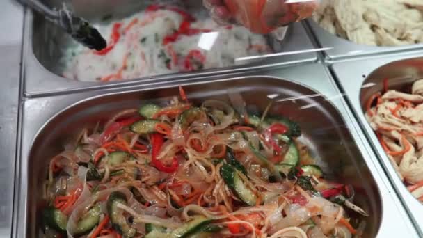 starch noodle salad with carrots and spices. sale of a ready-made dish on the market. Korean cuisine - Footage, Video