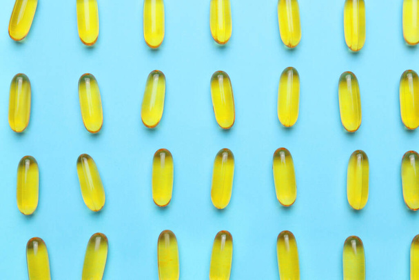 Fish oil capsules on color background - Фото, изображение