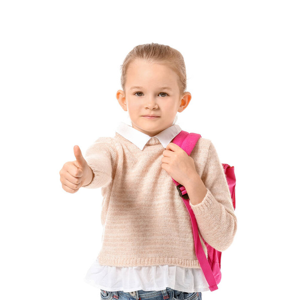 Söpö pieni koulutyttö osoittaa peukalo ylös valkoisella taustalla
 - Valokuva, kuva