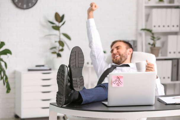 Young businessman relaxing in office - Photo, Image