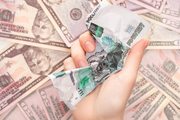 top view of woman holding crumpled ruble banknote near dollars  - 写真・画像