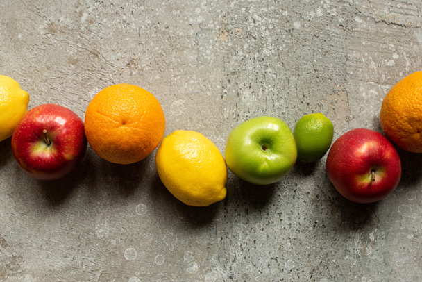 top view of tasty colorful fruits on grey concrete surface - 写真・画像