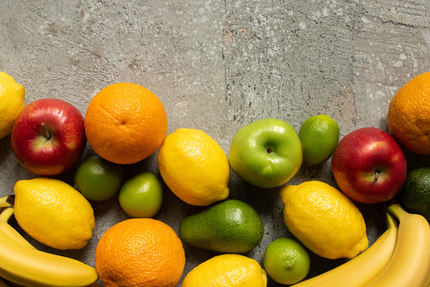 top view of tasty colorful fruits on grey concrete surface - Φωτογραφία, εικόνα