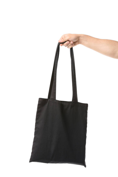 Male hand with eco bag on white background - Photo, image
