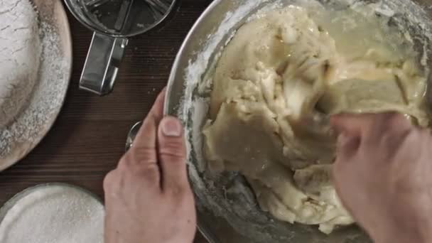 Kneading the dough. The process of making a delicious treat or dessert. Ingredients for baking on the table. Top plan for chef cook. Home cooking with care for relatives. - Footage, Video