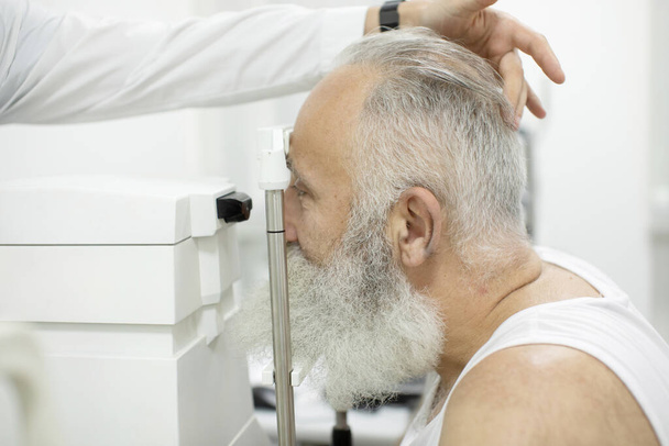 Senior patient checking vision with special eye equipment - Фото, зображення