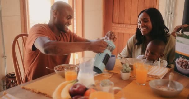Happy family having breakfast at home in the morning - Footage, Video