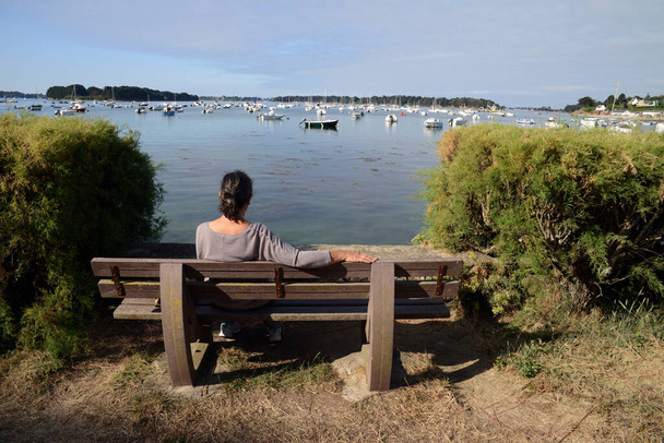Woman on a bench in Larmor Baden in Morbihan in Brittany  - Fotoğraf, Görsel