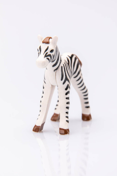 close up of a plastic stripped zebra isolated on a white background - Photo, Image