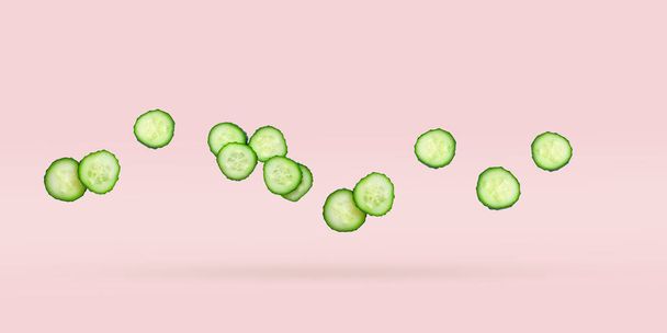Freshly organic cucumbers sliced  soaring on a pink background. Vegetables levitation concept.Coocing Ingredient, minimalistic grocery banner with copy space for text. - Foto, imagen