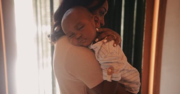 Loving mother holding sleeping baby boy in her arms - Materiał filmowy, wideo