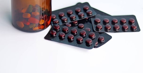 Ferro Fumaraat pillen in verpakkingen met tabletten, capsules, vitaminen in bruine fles voor de behandeling van ijzertekort bloedarmoede ziekte, recept medicatie dosering van de arts, geïsoleerd in witte achtergrond. - Foto, afbeelding