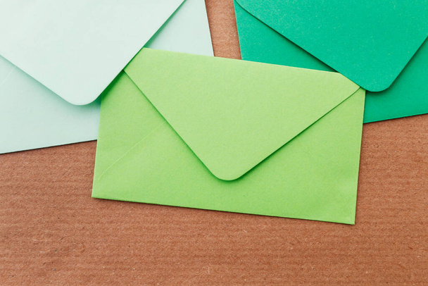Colorful envelopes on brown paper background, copy space. - Фото, зображення
