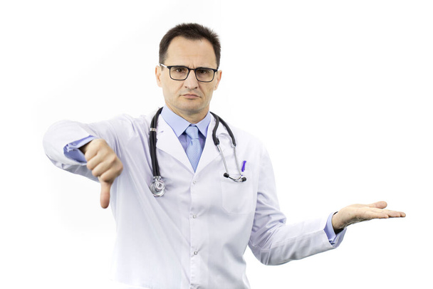 Serious doctor shows dislike sign holding empty palm with object - Photo, Image