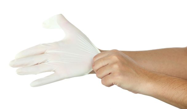 Doktor si nasazuje ochranné rukavice, izolované na bílém - Fotografie, Obrázek