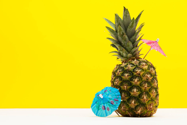 Tropical summertime pineapple with a cocktail umbrella - Φωτογραφία, εικόνα