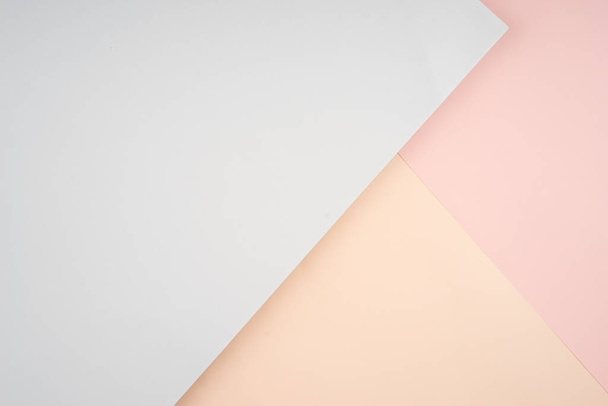 Kreative Anordnung weicher pastellfarbener Papiere, die einen abstrakten Hintergrund schaffen - Foto, Bild